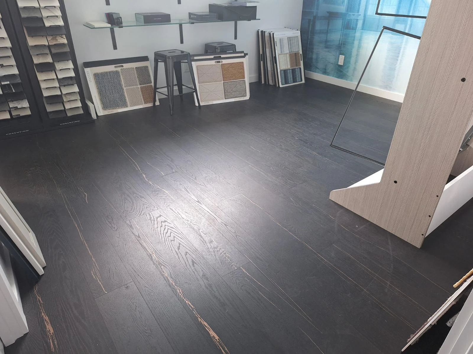 Dark plank flooring laid across a large open room