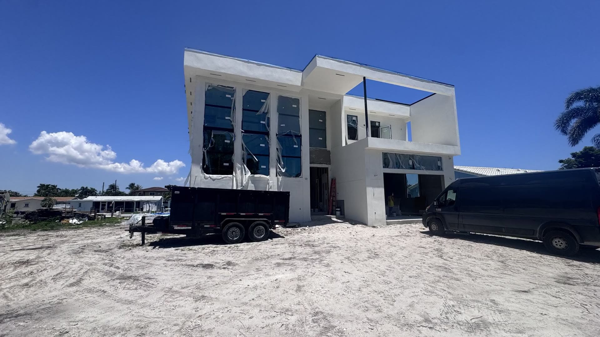 Two-story Elbaz Construction residence under construction on a South Florida canal lot