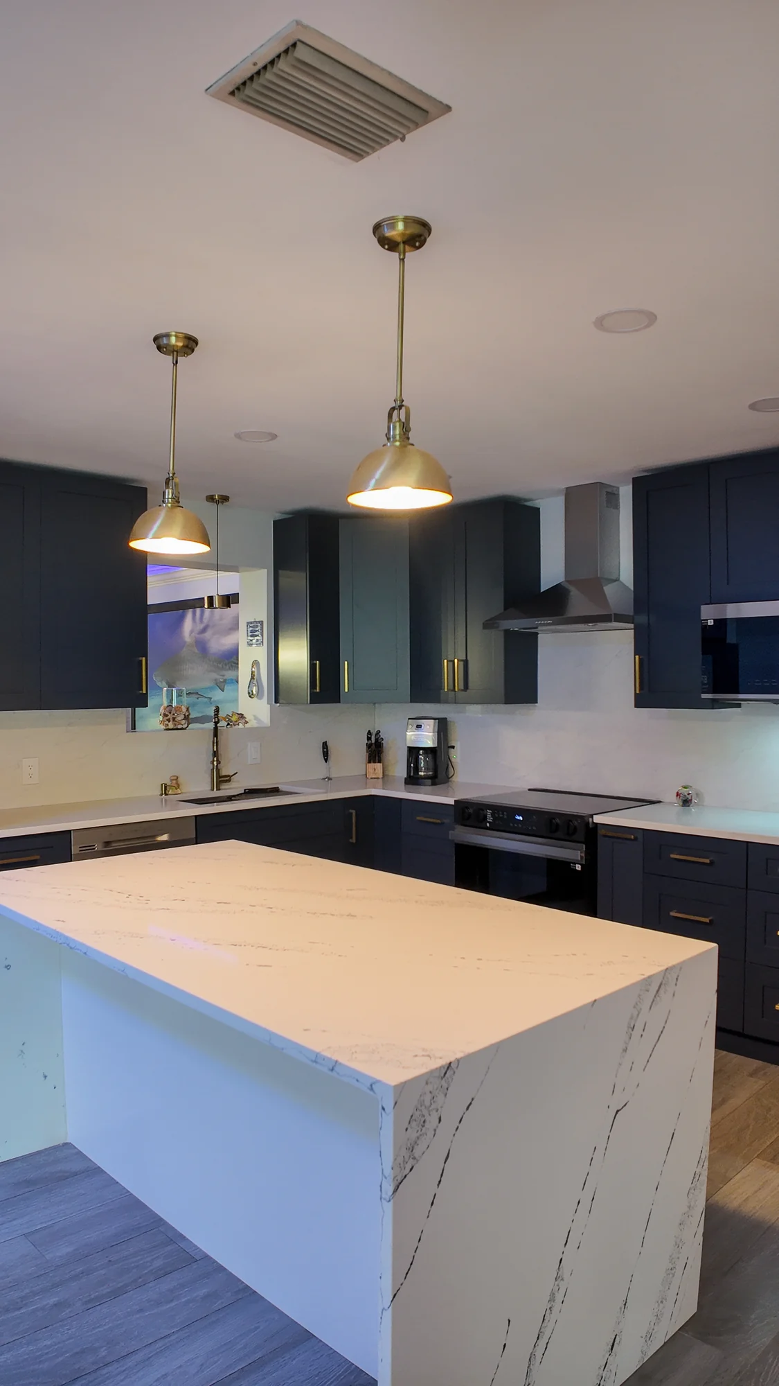 Completed kitchen island with a waterfall worktop edge