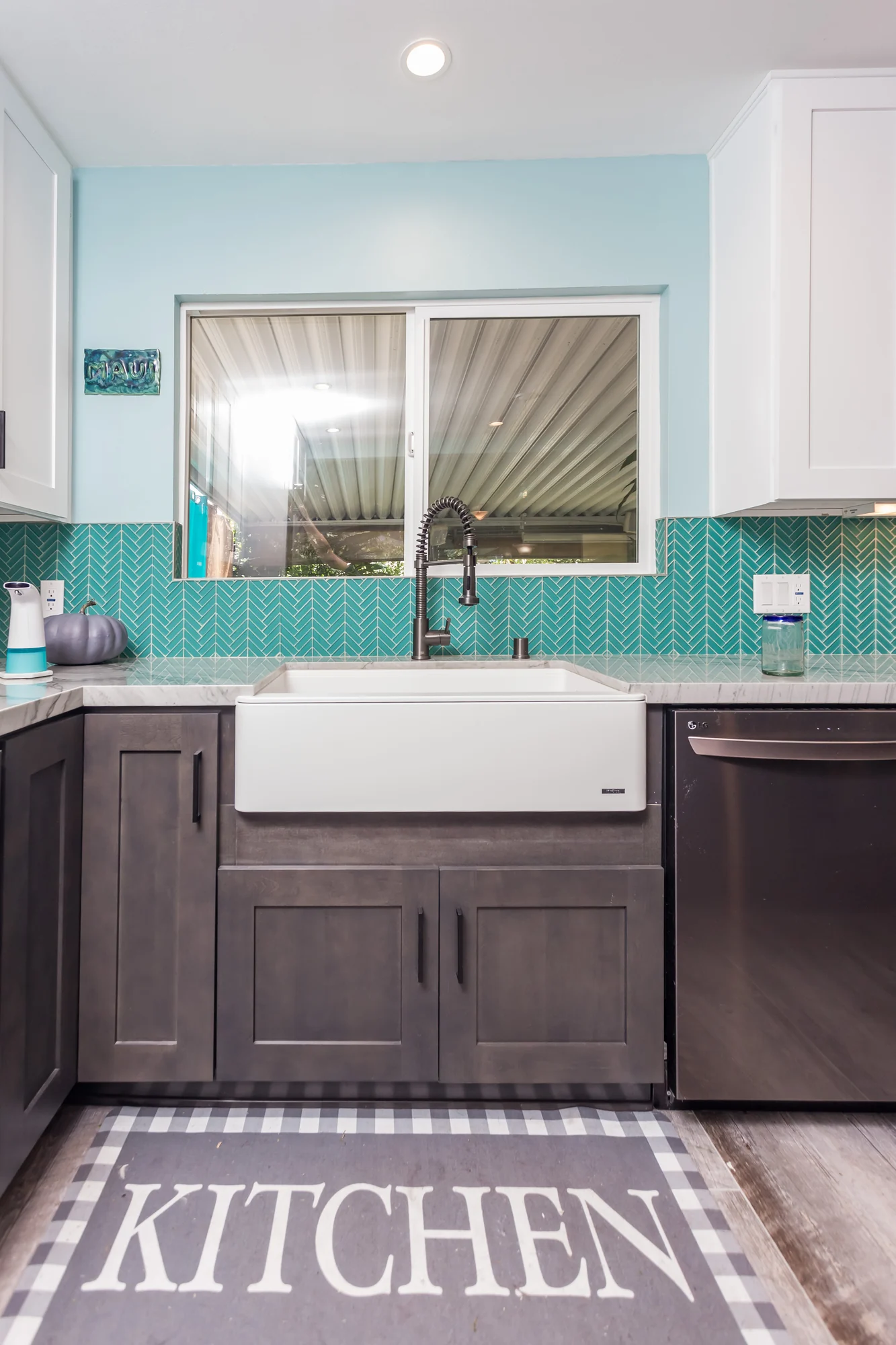Renovated kitchen with a farmhouse sink and tiled splashback