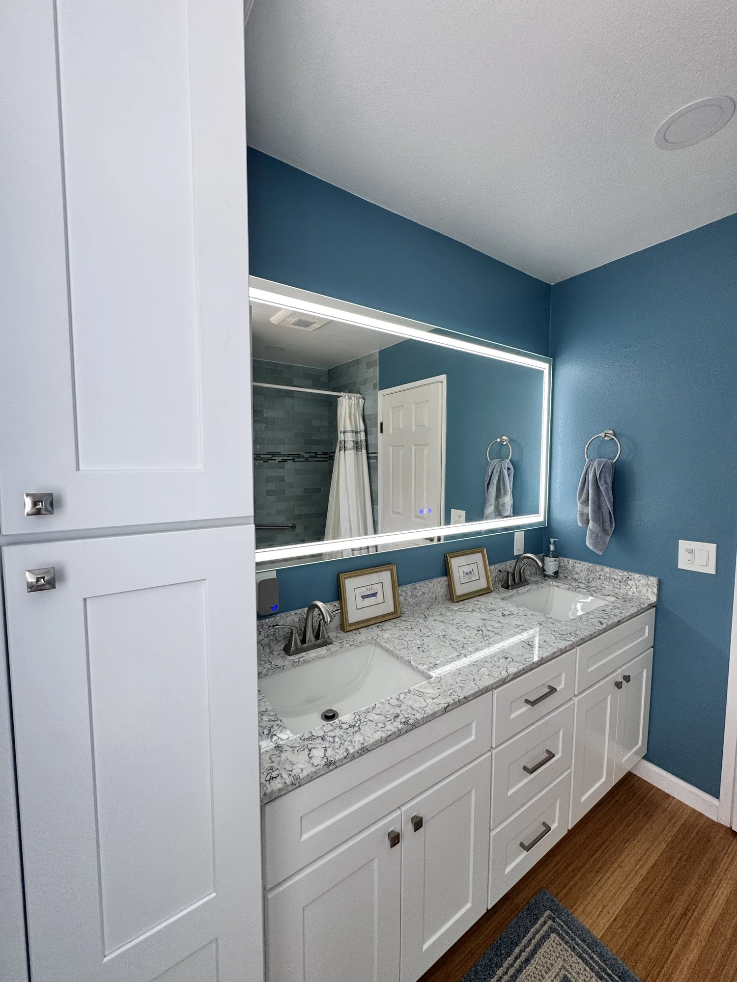 Completed bathroom vanity, mirror and floor covering