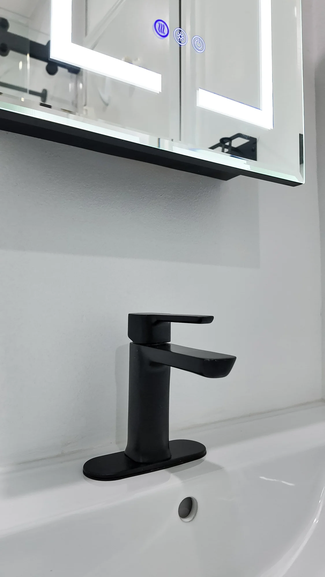 Bathroom mirror and tap detail in a completed remodel
