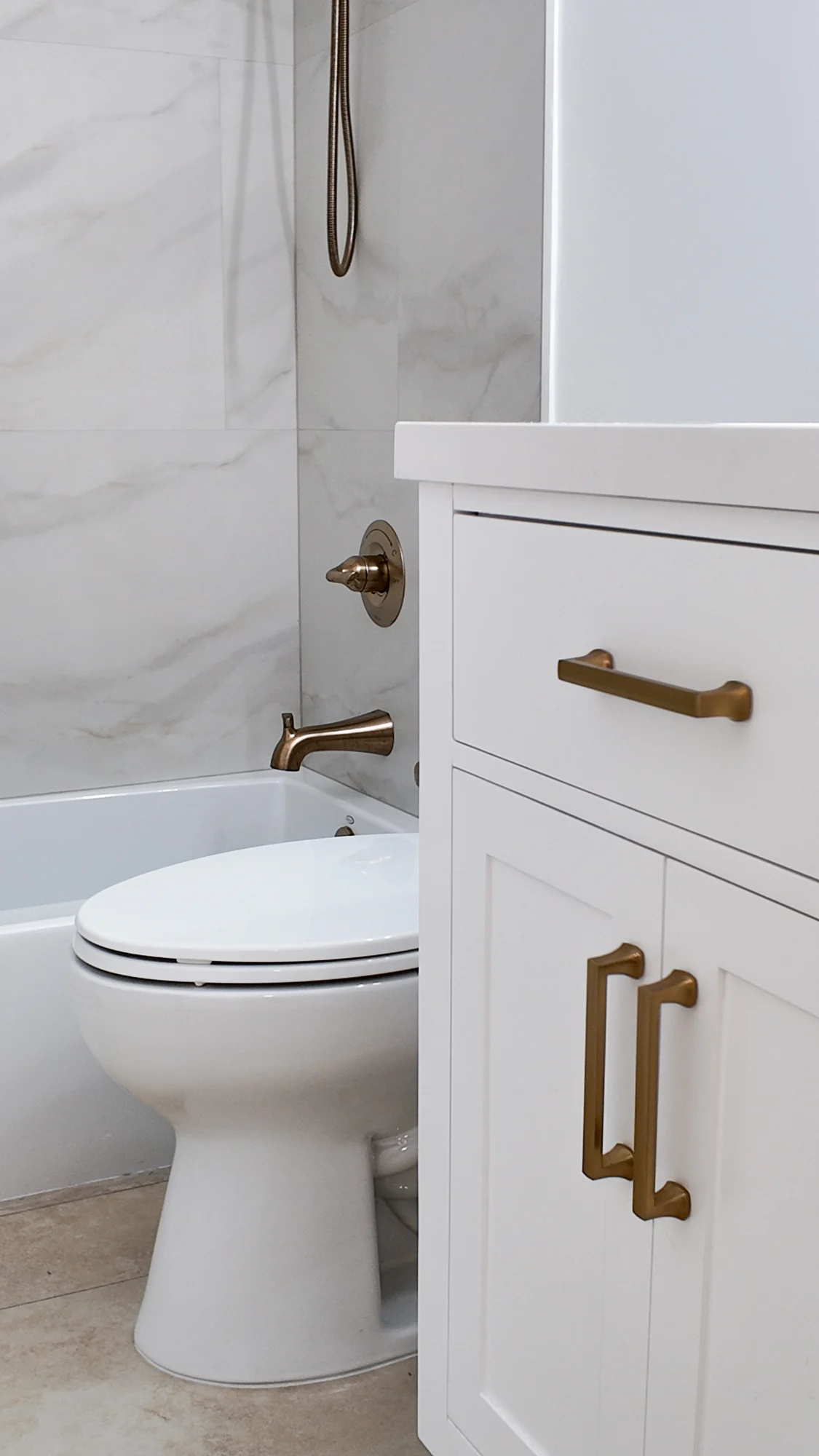 Completed bathroom with toilet and brushed brass fittings