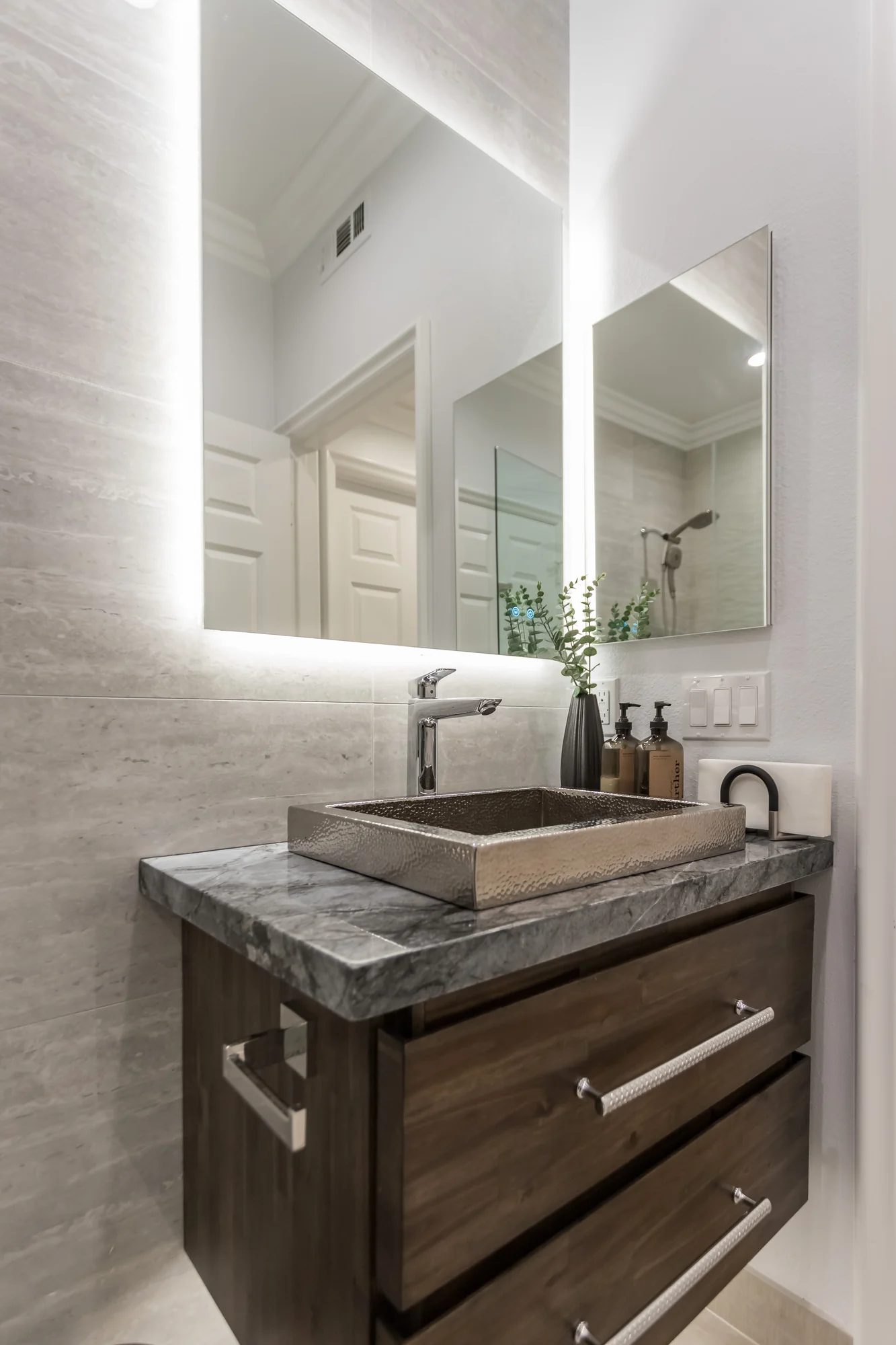 Compact bathroom vanity and mirror in a South Florida home