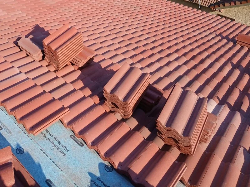 Roof tiles laid over underlayment during installation