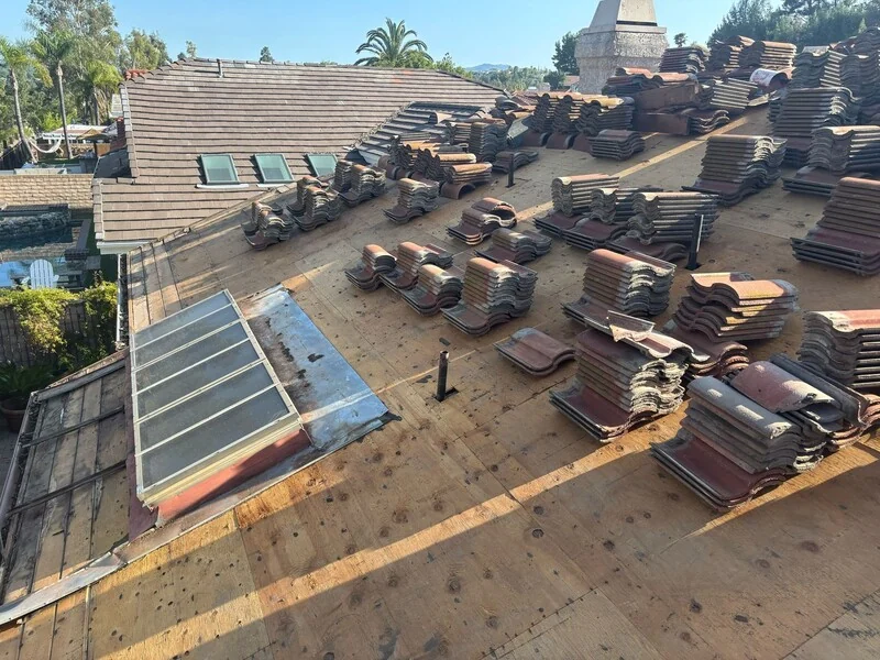 Tile loaded out across a roof deck ready for installation