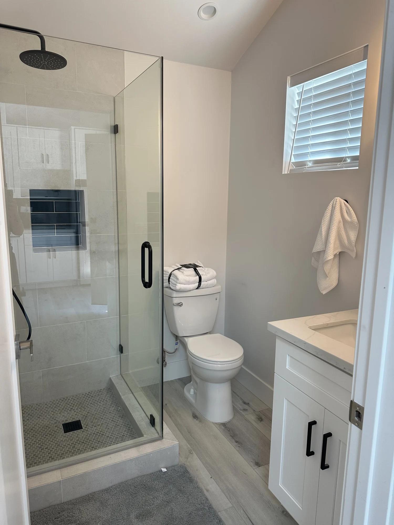 Bathroom with a glass shower enclosure in a completed accessory unit