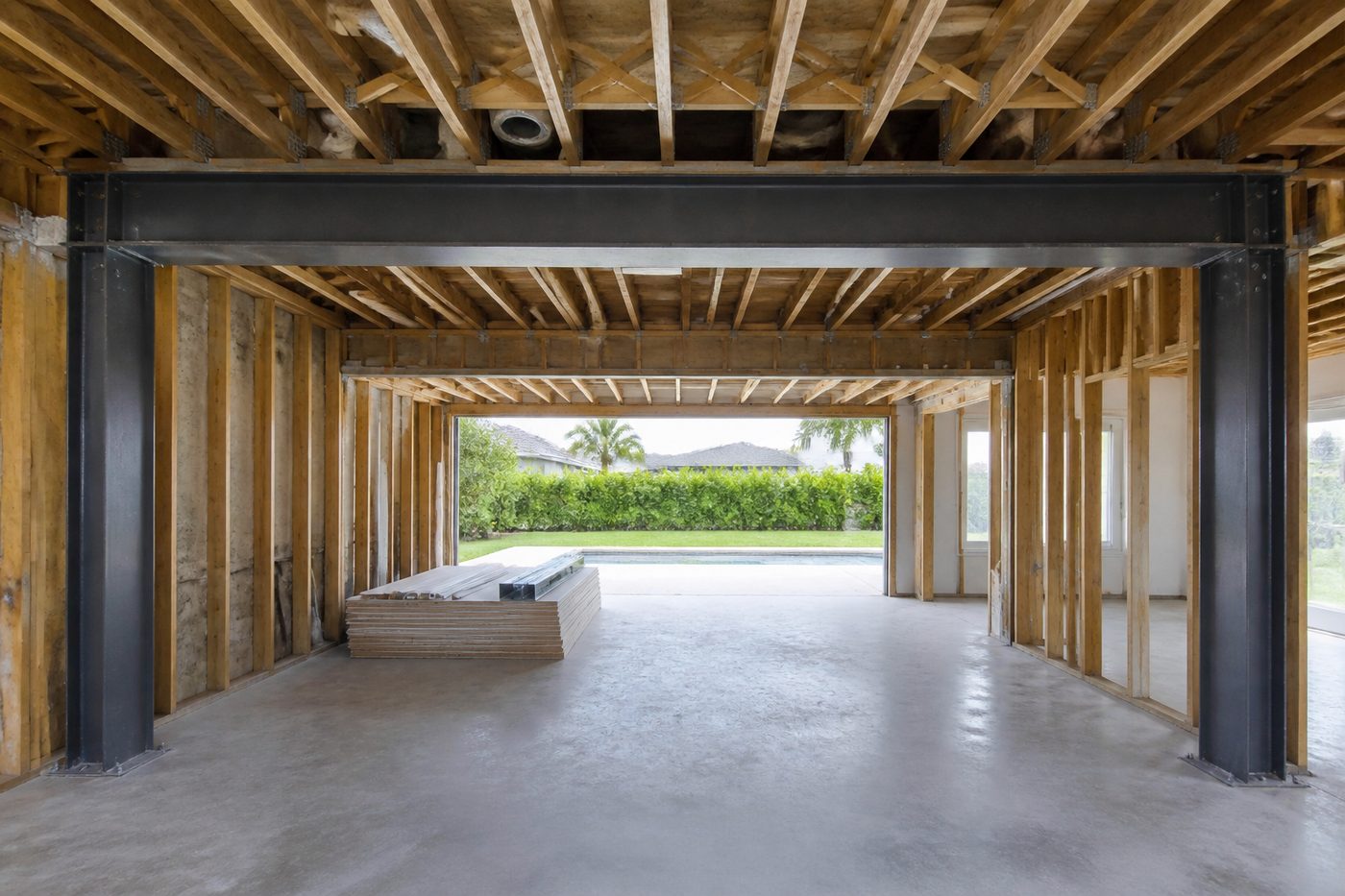 AI-generated illustration: a steel beam and bearing columns installed where a load-bearing wall was removed for an addition