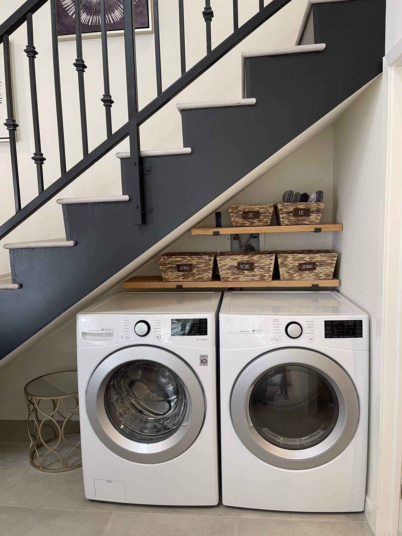 Stacked washer and dryer set into the space beneath an ADU stair