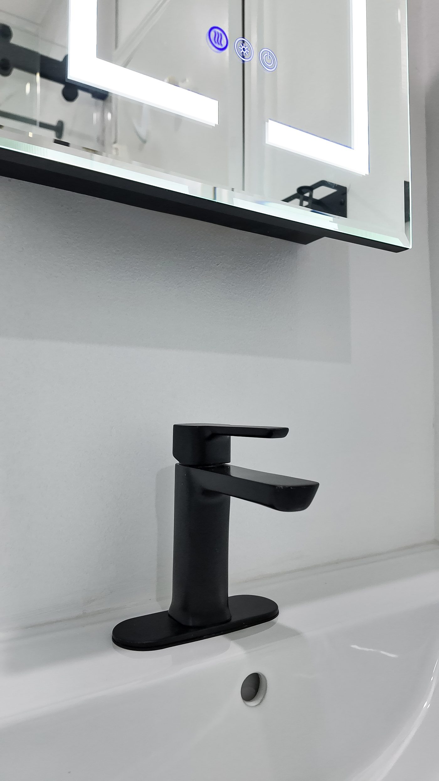 Matt black single-lever basin mixer on an integrated white vanity top