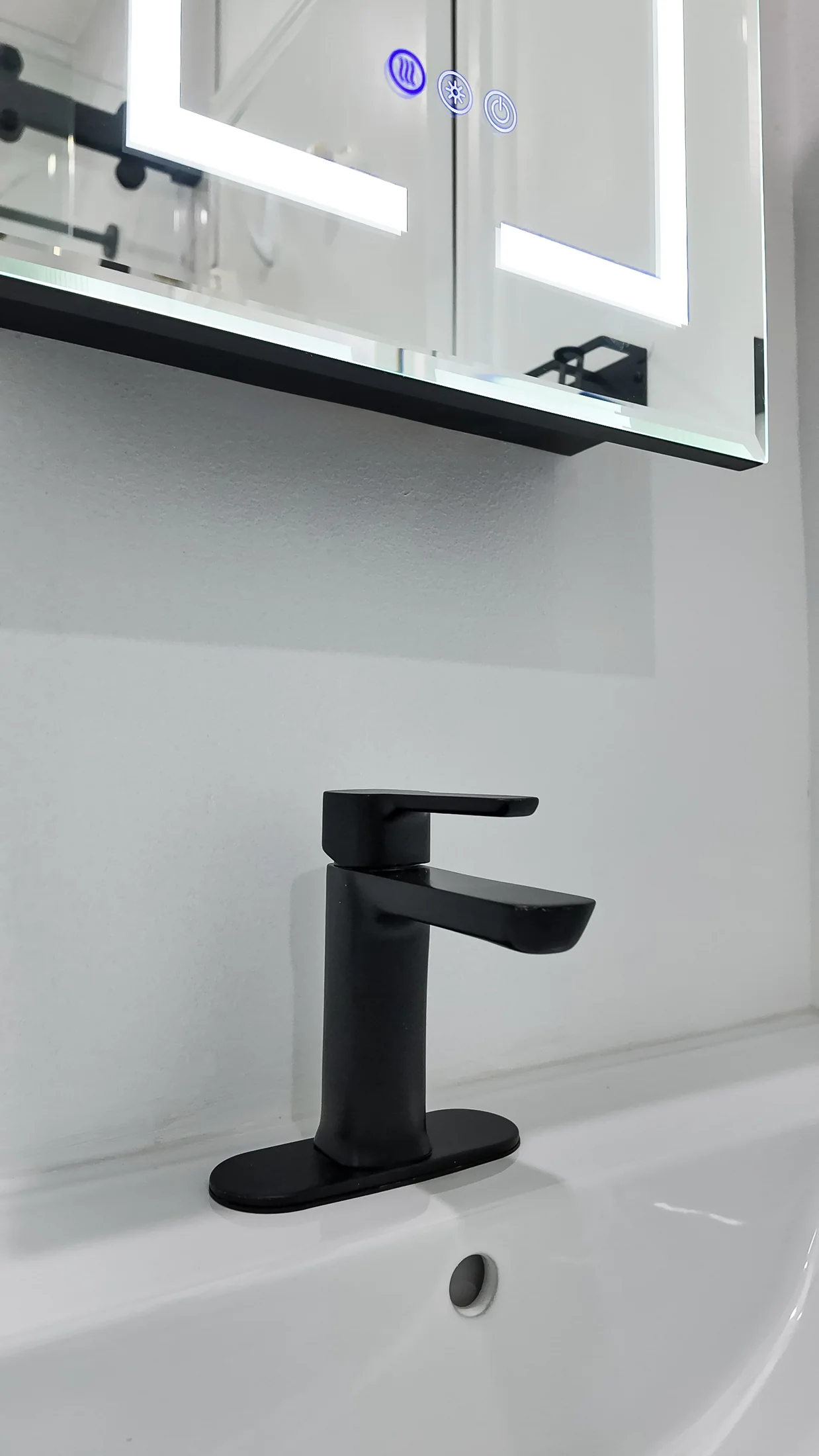 Close view of a matt black basin tap on a white countertop basin
