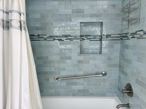Completed bathroom remodel with tiled shower surround