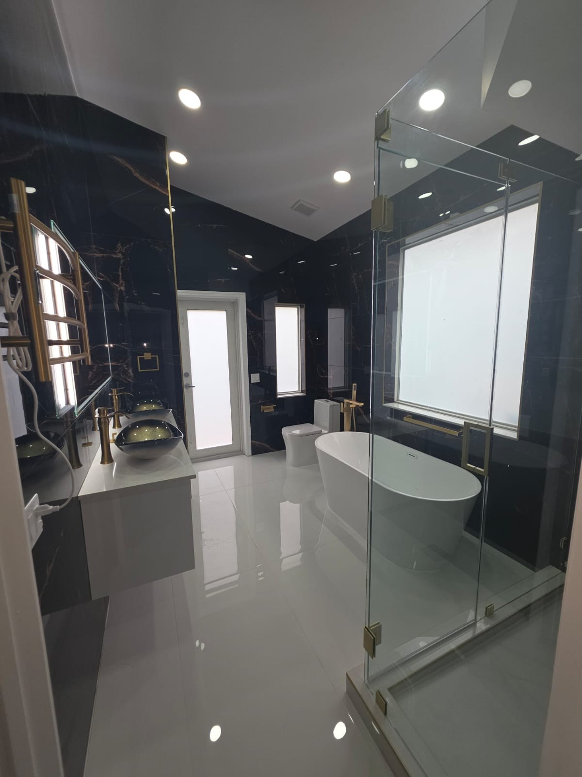 Black Marble Primary Bathroom with Freestanding Tub & Glass Wet Room
