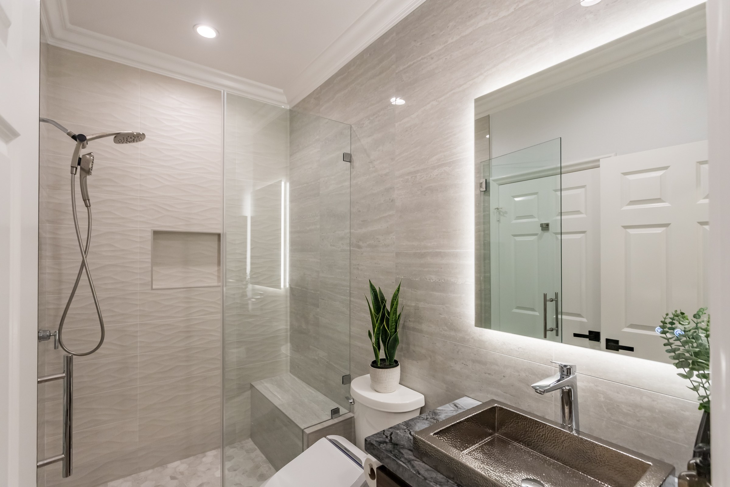 Modern Bathroom Remodel with Frameless Glass Shower & Hammered Nickel Vessel Sink