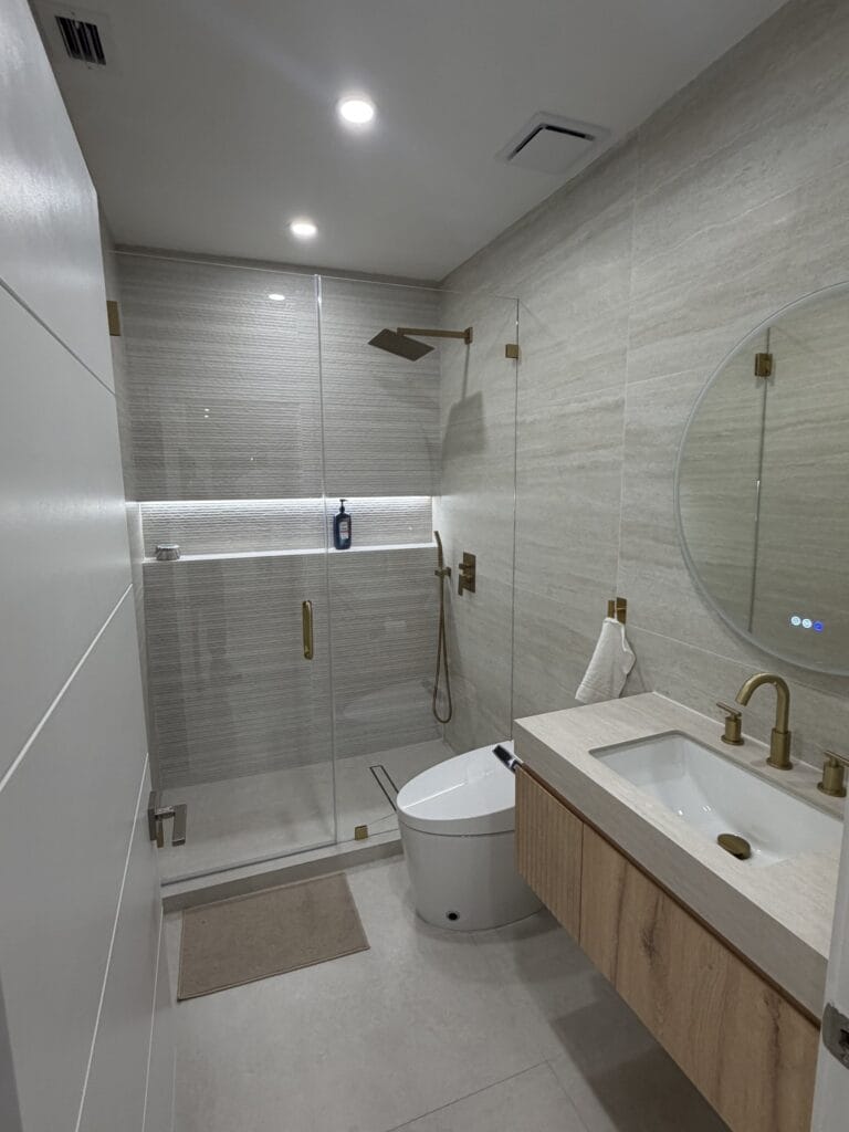 Guest Bathroom Remodel with Frameless Glass Shower and Brass Accents — photo 2