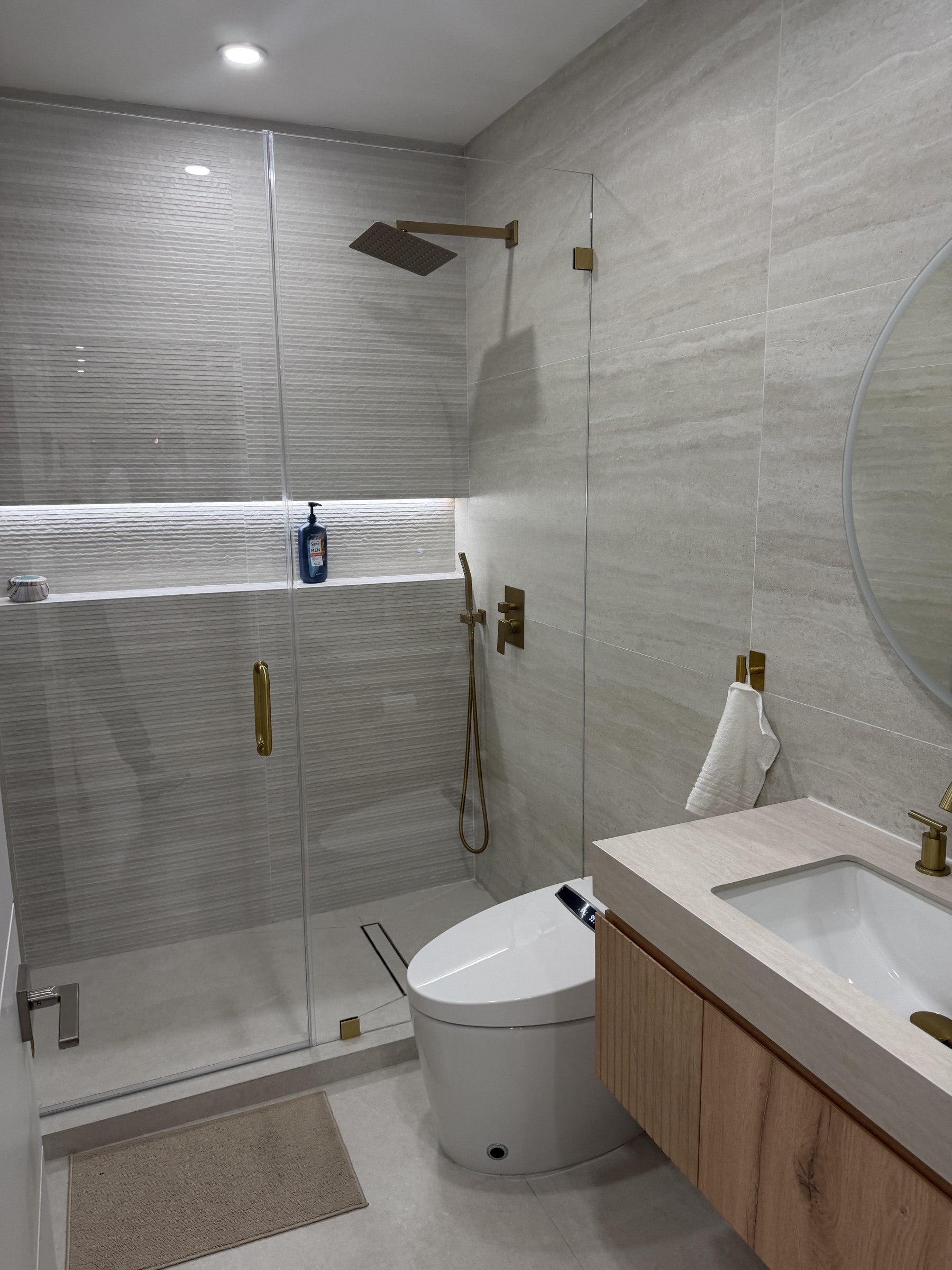 Guest Bathroom Remodel with Frameless Glass Shower and Brass Accents