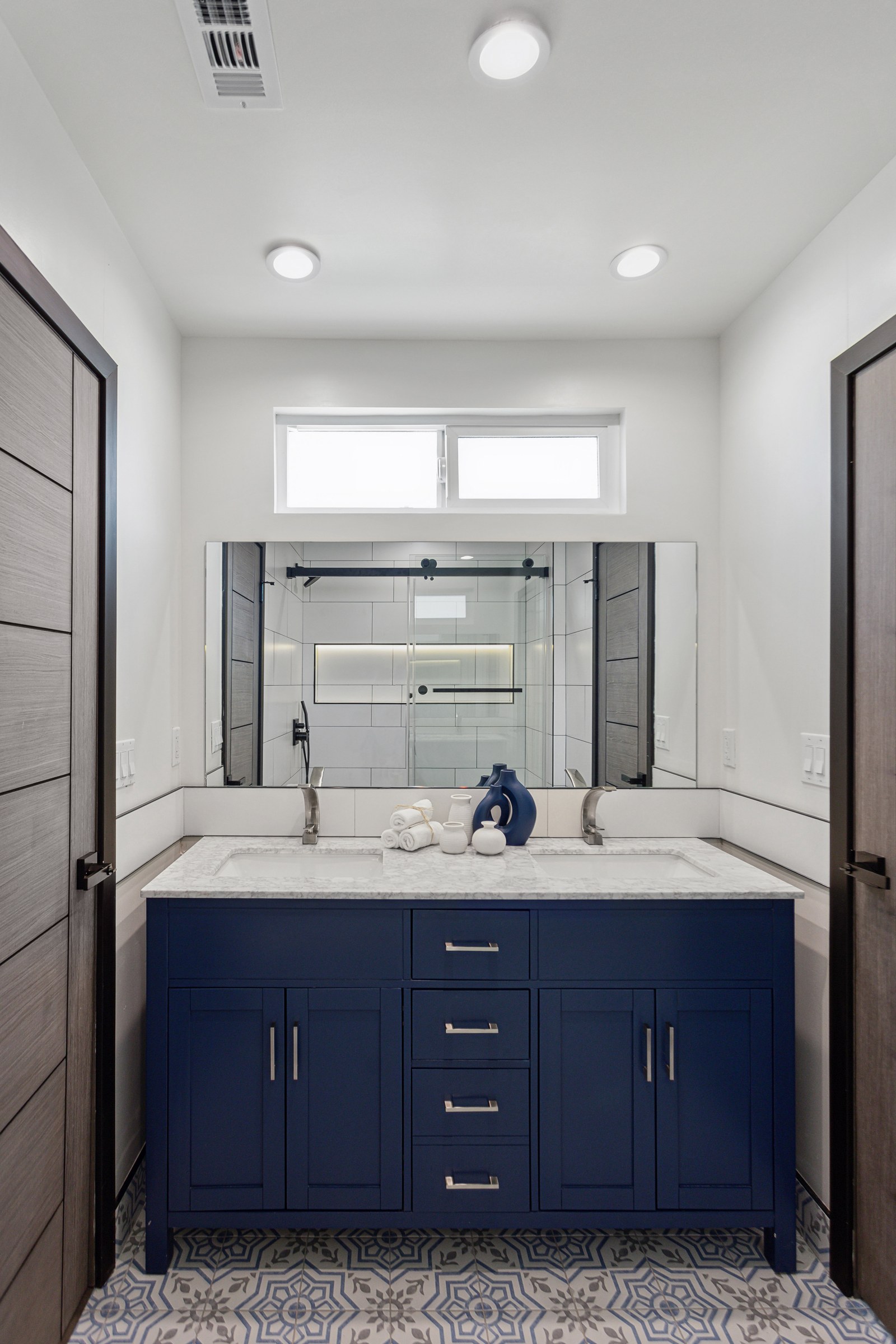 Navy Vanity Bathroom Remodel with Backlit Tile Niche