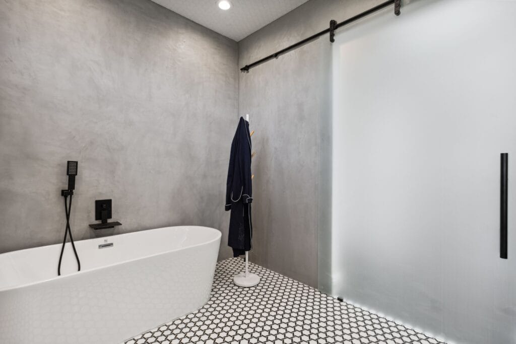 Polished-Concrete Primary Bath with Curbless Walk-In Shower — photo 12