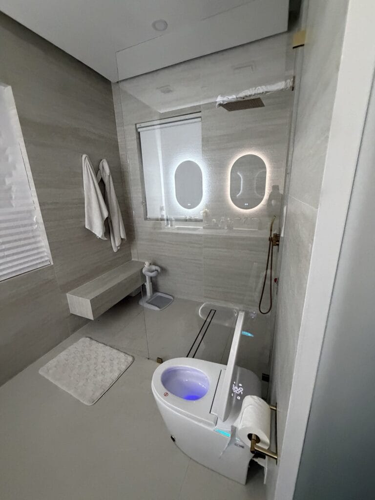 Spa-Style Guest Bathroom Remodel with Curbless Shower & Backlit Mirrors — photo 4