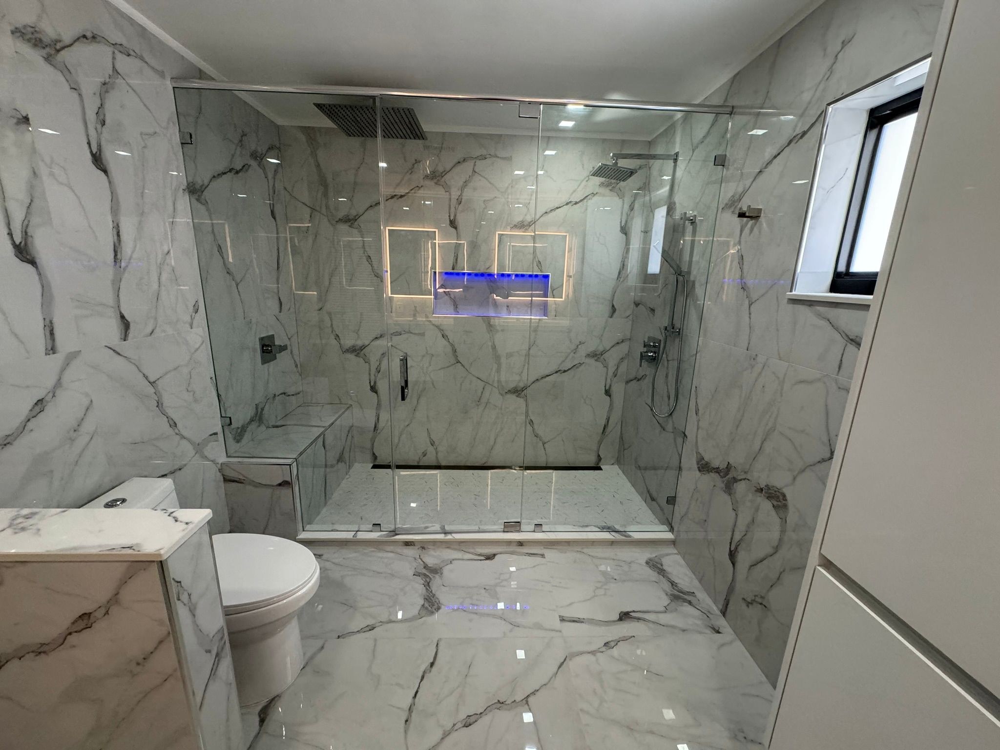 White Marble Guest Bath & Grey Stone Primary Suite Renovation