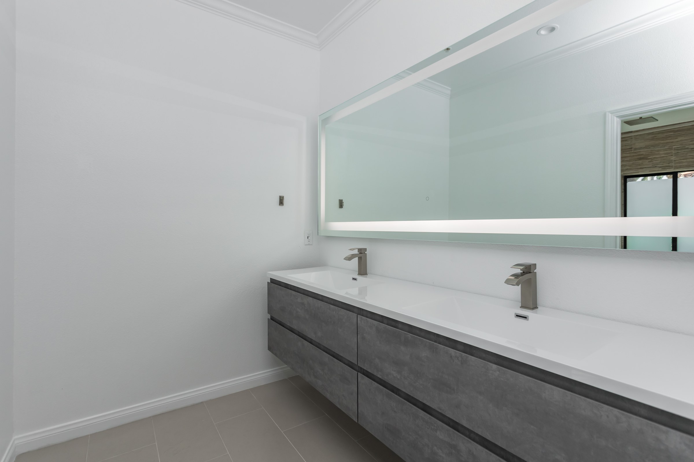 Whole-Home Bathroom Renovation with Spa Showers & a Freestanding Soaking Tub