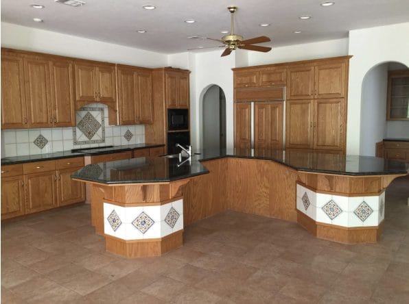 Kitchen with dated oak cabinetry and tiled counters, before renovation