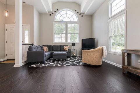 Open-concept living room with dark stained hardwood plank flooring