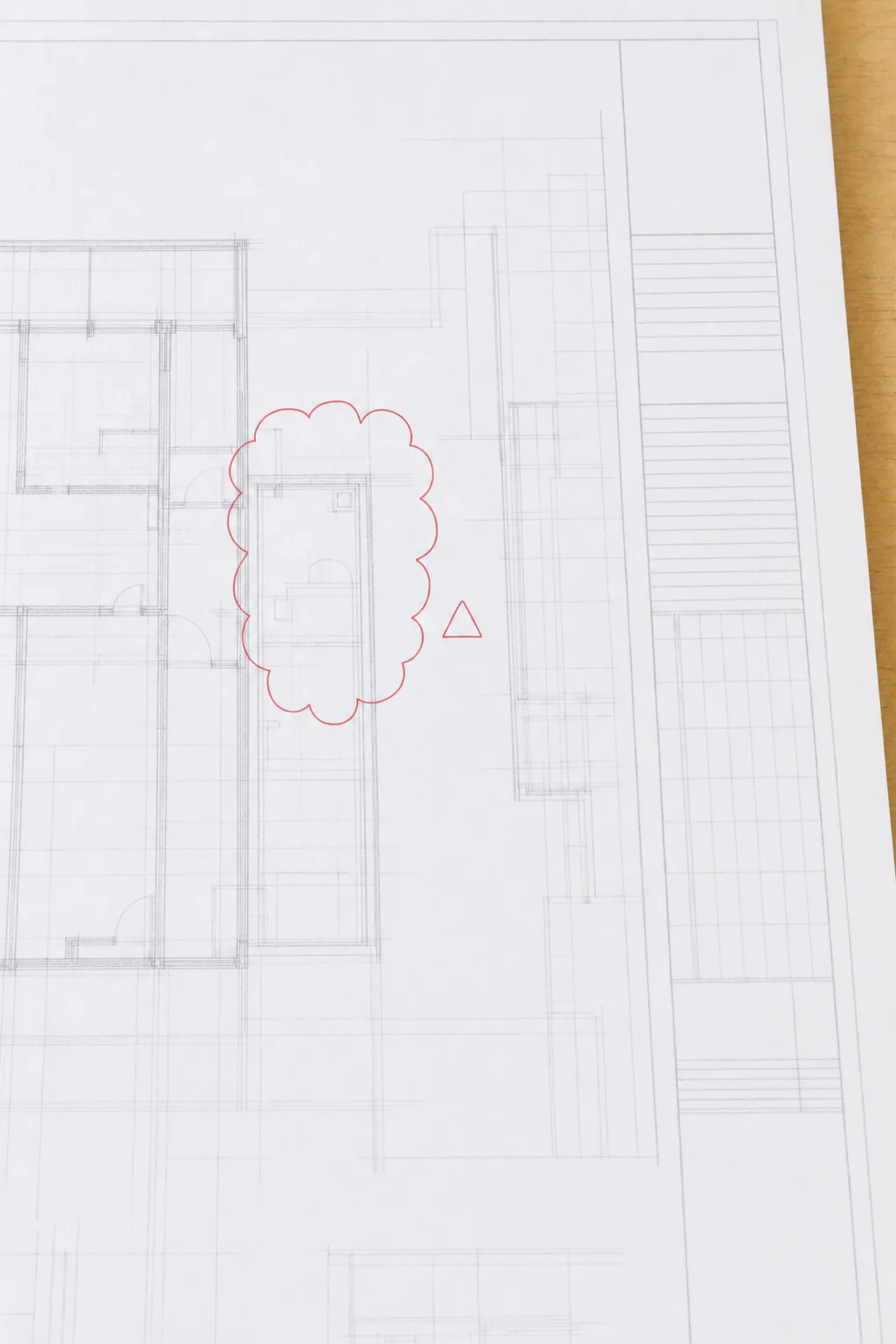 Illustration of a revision cloud and delta symbol marked on a revised drawing sheet beside a ruled revision block