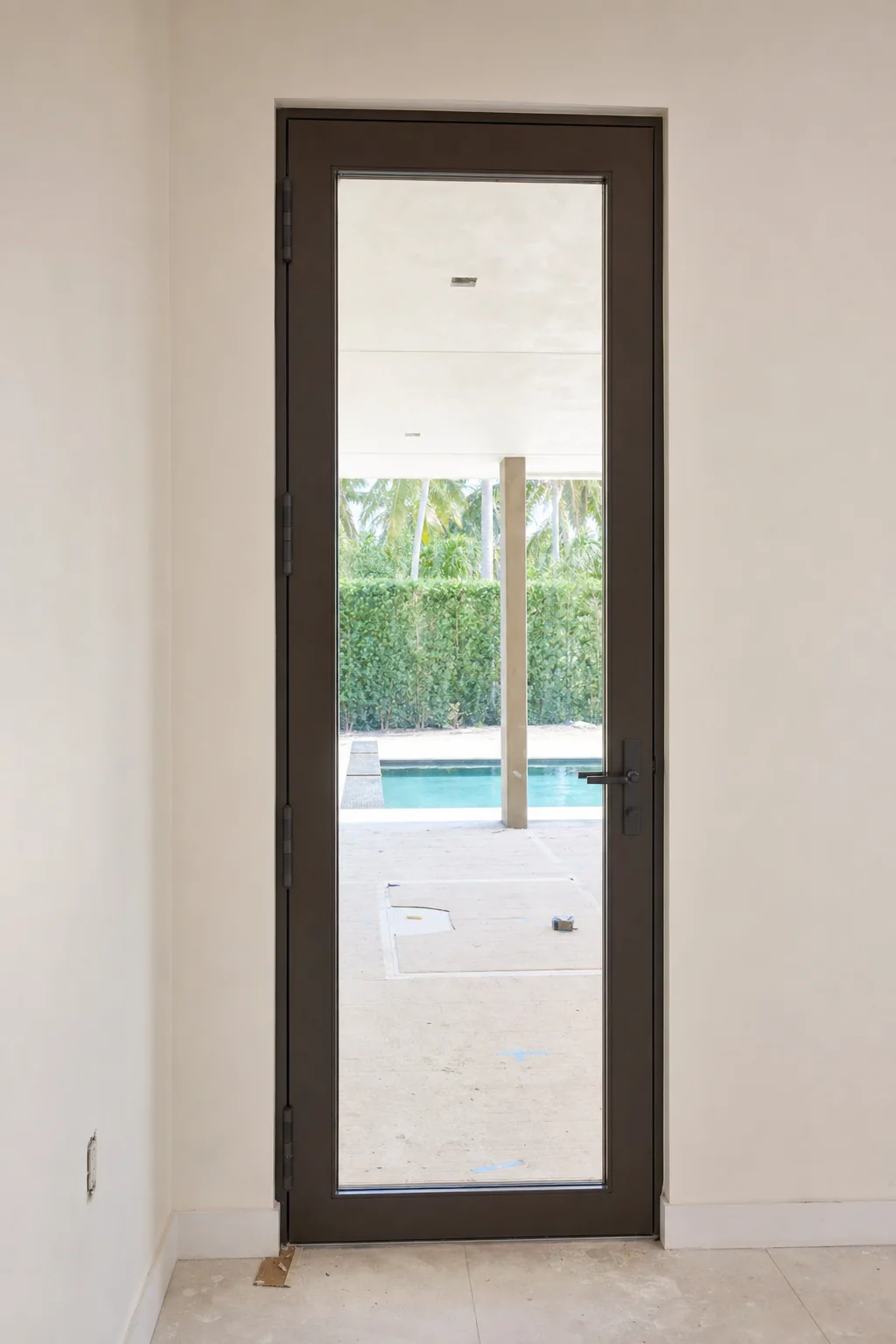 Illustration of a single-leaf hinged French door in a white stucco wall with its butt hinges visible on the jamb