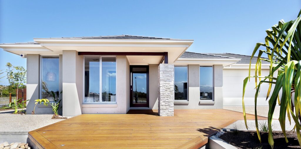 Impact window and sliding glass door installation by Elbaz Construction across South Florida: aluminium-framed impact glazing in stucco openings, on waterfront and single-storey homes