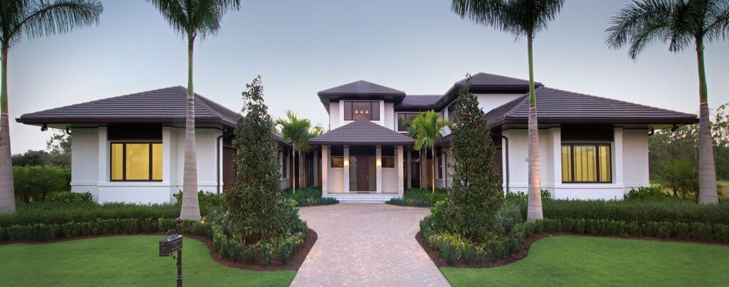 Impact window and sliding glass door installation by Elbaz Construction across South Florida: aluminium-framed impact glazing in stucco openings, on waterfront and single-storey homes