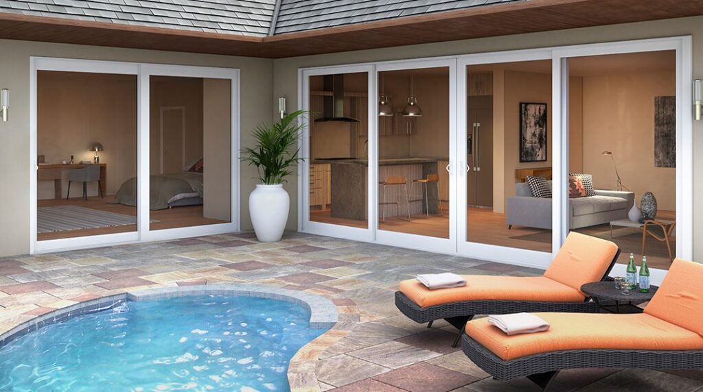 Impact window and sliding glass door installation by Elbaz Construction across South Florida: aluminium-framed impact glazing in stucco openings, on waterfront and single-storey homes