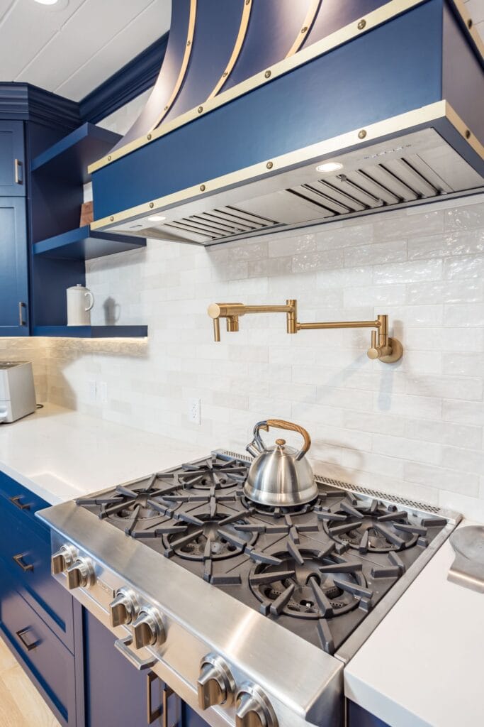 Navy Blue Shaker Kitchen with Brass Hardware and a Custom Range Hood — photo 21