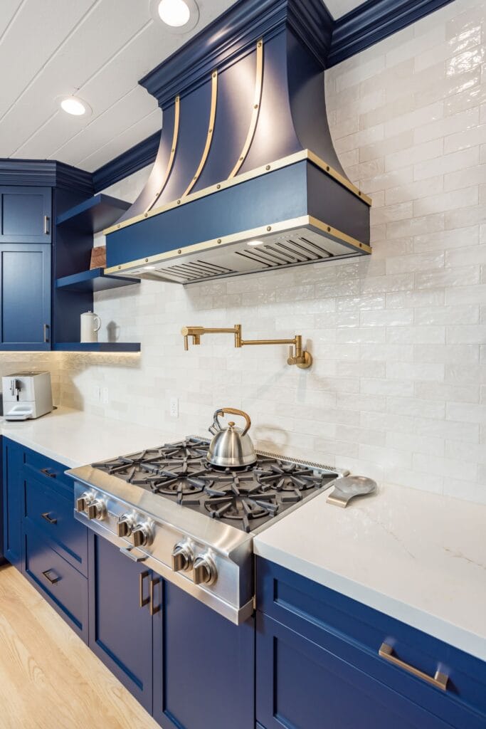 Navy Blue Shaker Kitchen with Brass Hardware and a Custom Range Hood — photo 22