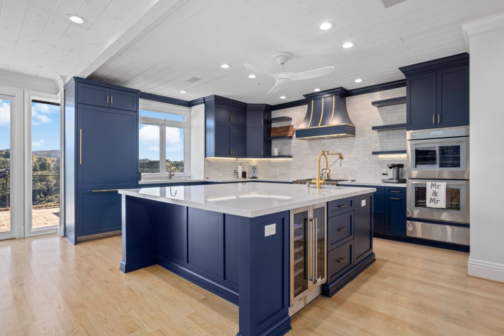 Navy Blue Shaker Kitchen with Brass Hardware and a Custom Range Hood