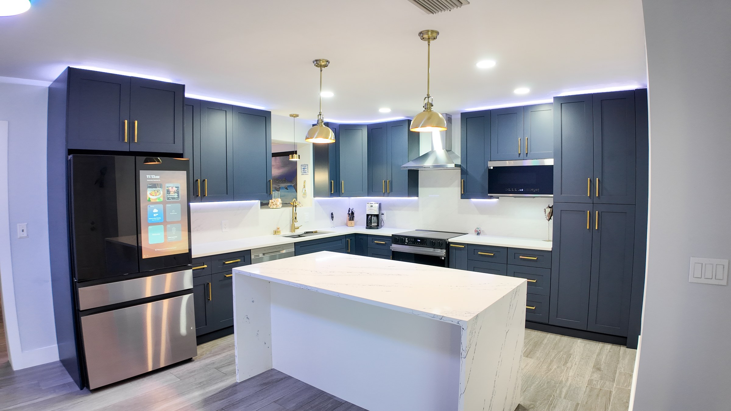 Two-Tone Navy & White Kitchen Remodel with Waterfall Quartz Island