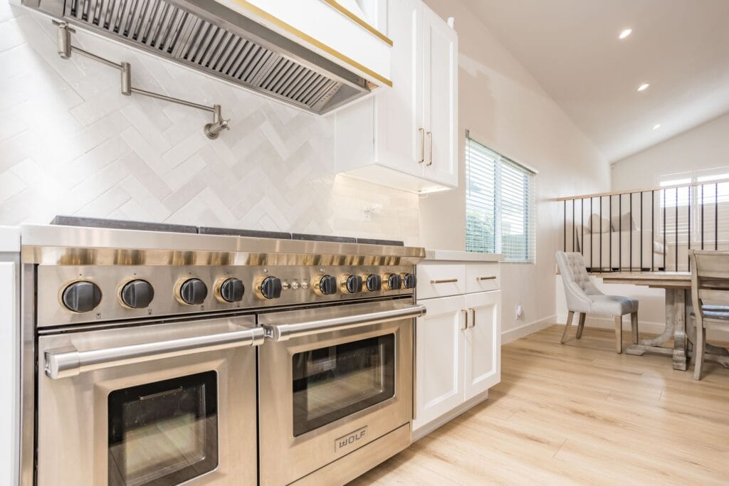 Two-Tone Kitchen Remodel with Custom Brass-Banded Range Hood — photo 7