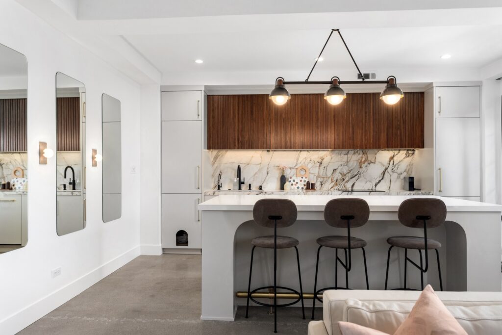 Open-Concept Kitchen Remodel with Fluted Walnut Cabinetry and Bookmatched Marble — photo 2