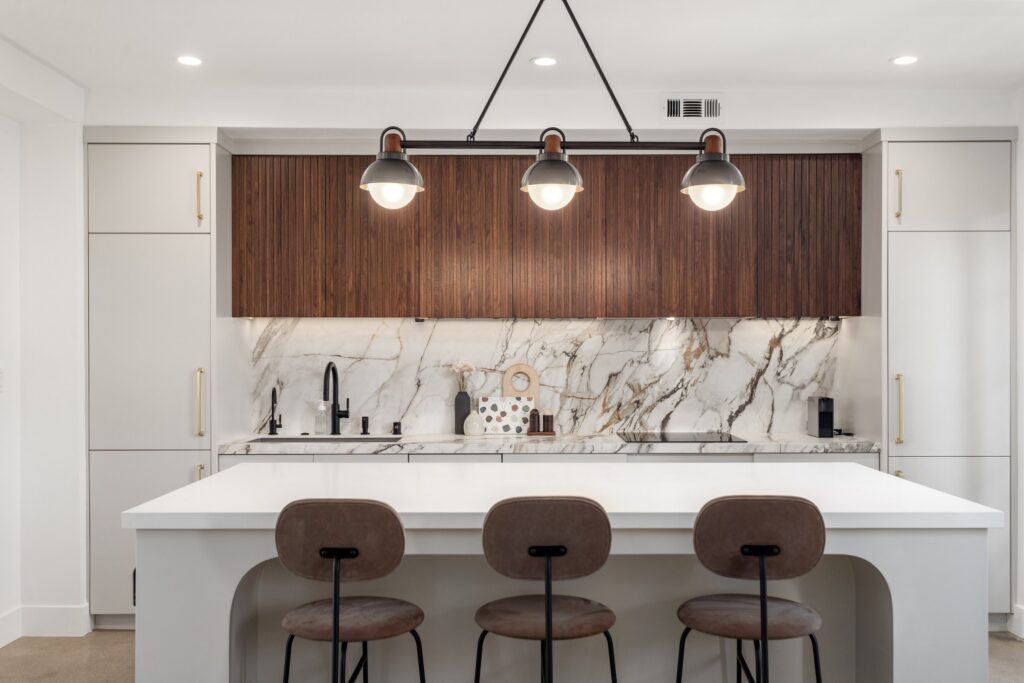 Open-Concept Kitchen Remodel with Fluted Walnut Cabinetry and Bookmatched Marble — photo 3