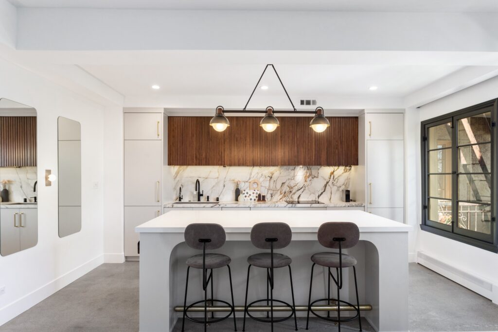 Open-Concept Kitchen Remodel with Fluted Walnut Cabinetry and Bookmatched Marble — photo 4