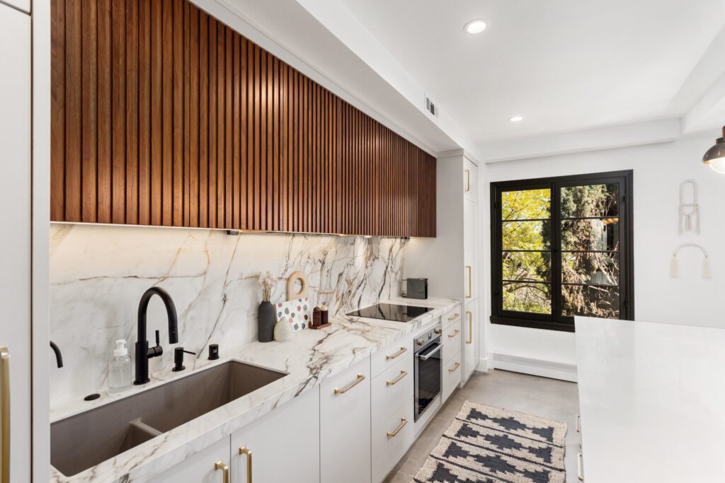 Open-Concept Kitchen Remodel with Fluted Walnut Cabinetry and Bookmatched Marble — photo 13