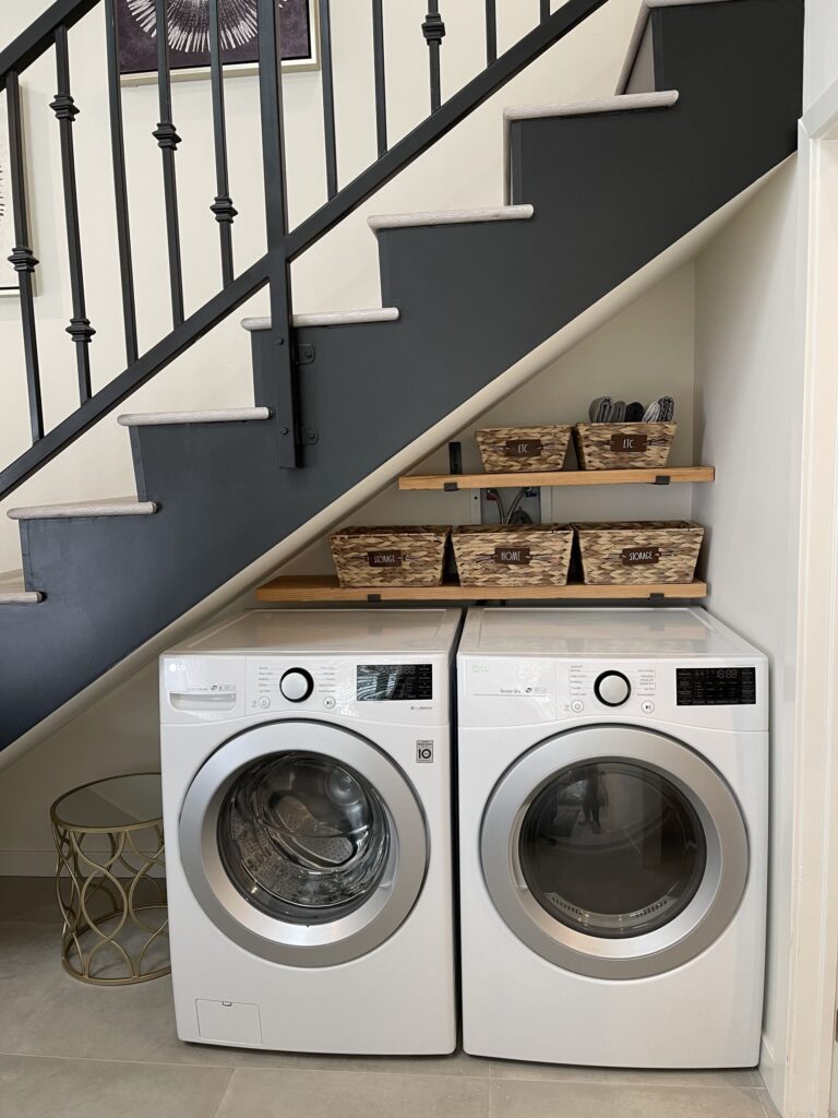 A larger two-storey ADU by Elbaz Construction with a loft bedroom, full kitchen and laundry, shown for scale against a studio unit