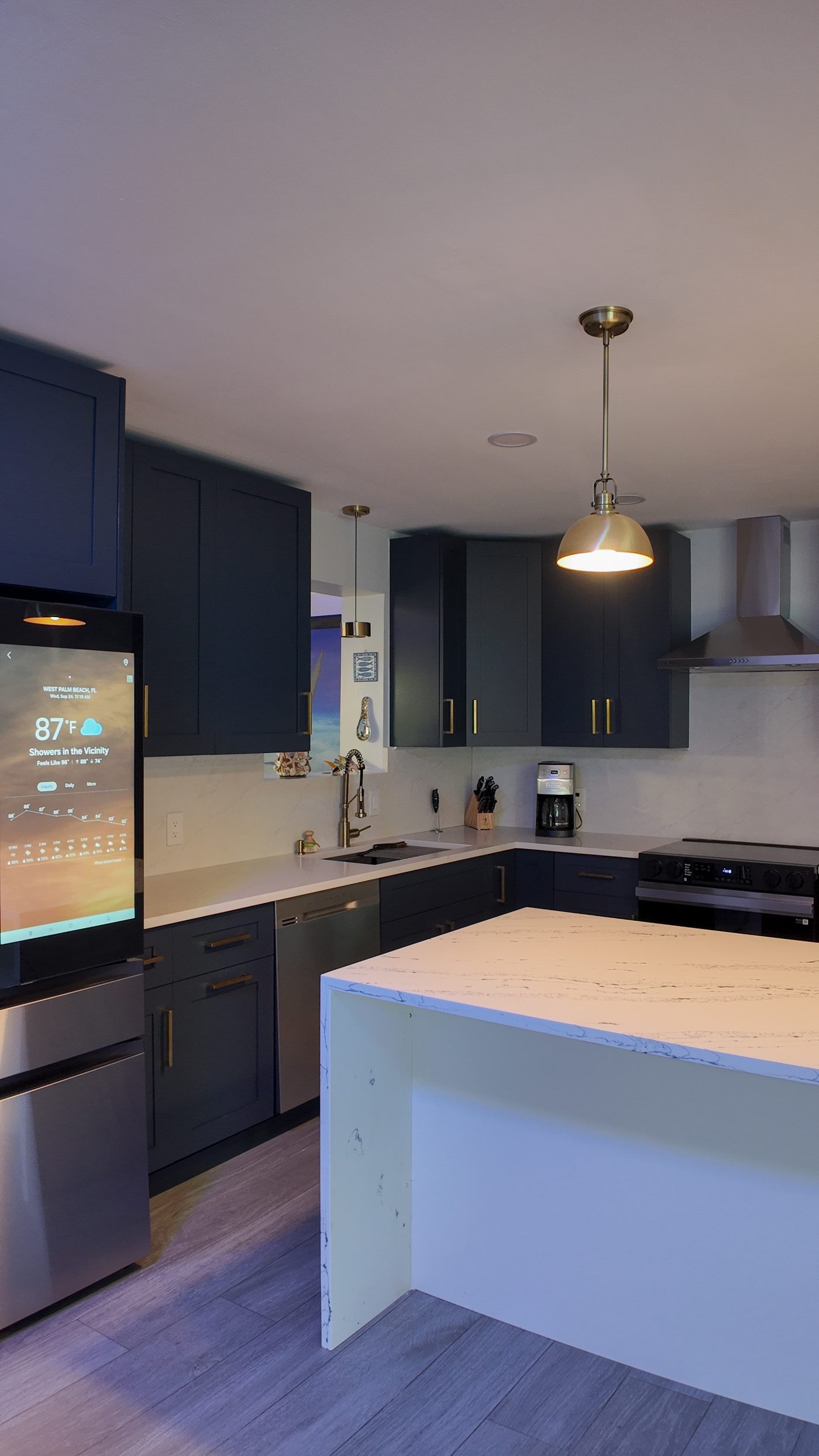 Kitchen island and cabinet run seen from the dining side of an open-plan room