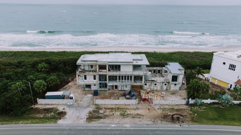 Aerial view of a concrete-block luxury home under construction near the water