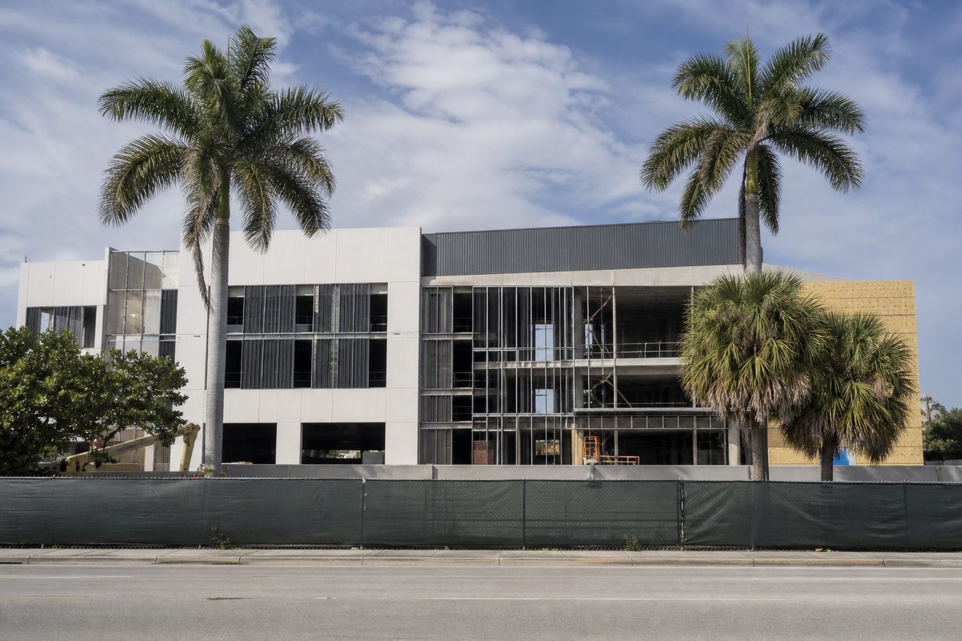 AI-generated illustration: a commercial building under construction behind site hoarding