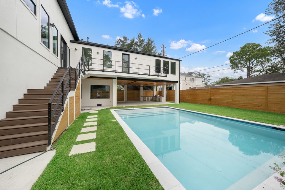 Rear exterior with pool, terrace and second-floor balcony