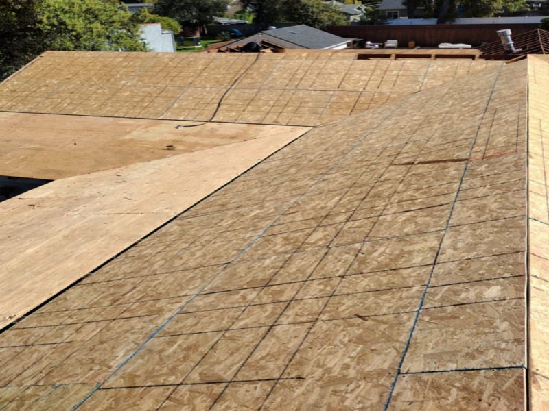 New plywood roof decking installed over the existing framing