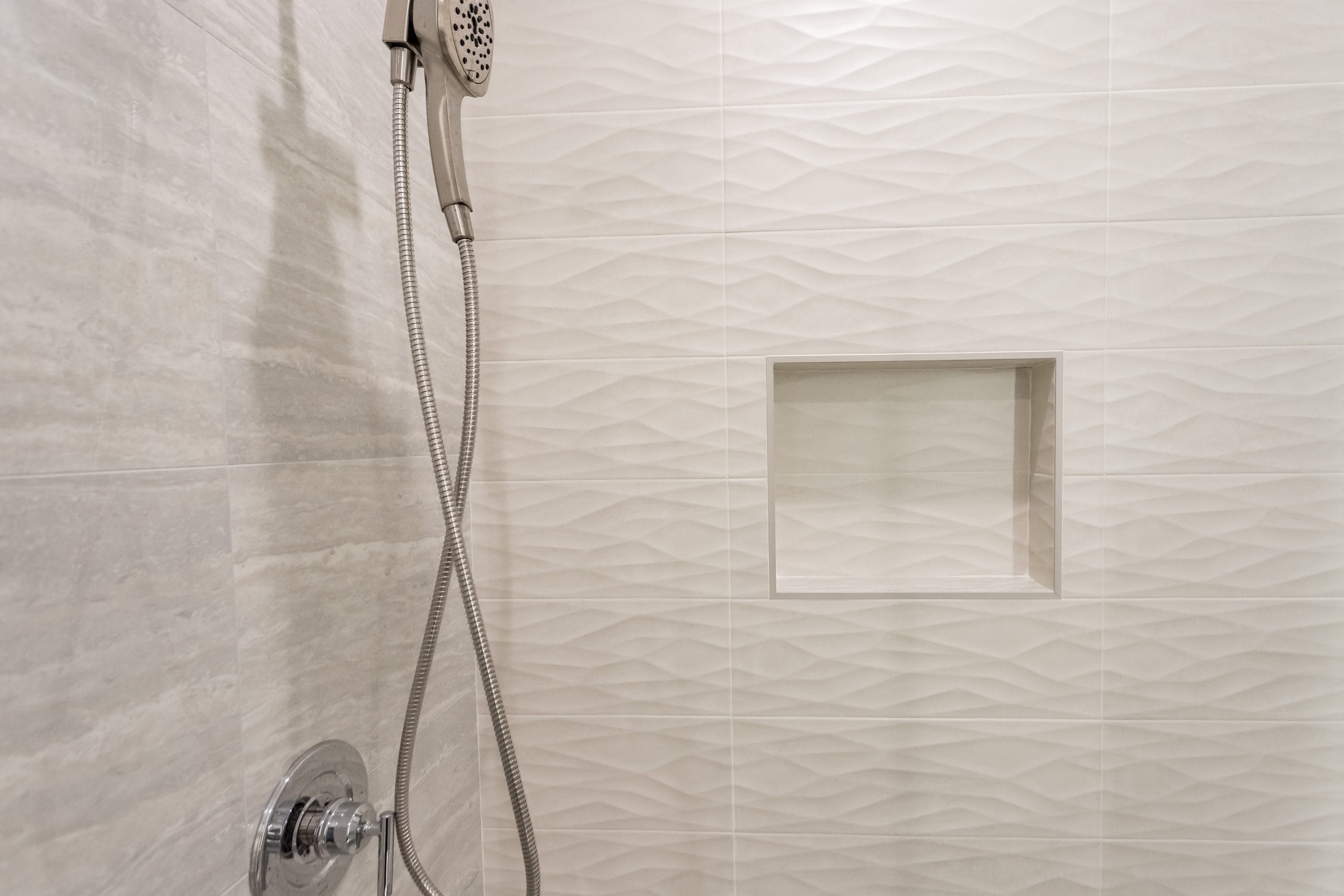 Shower valve, hand shower and the recessed niche in the wave-textured tile