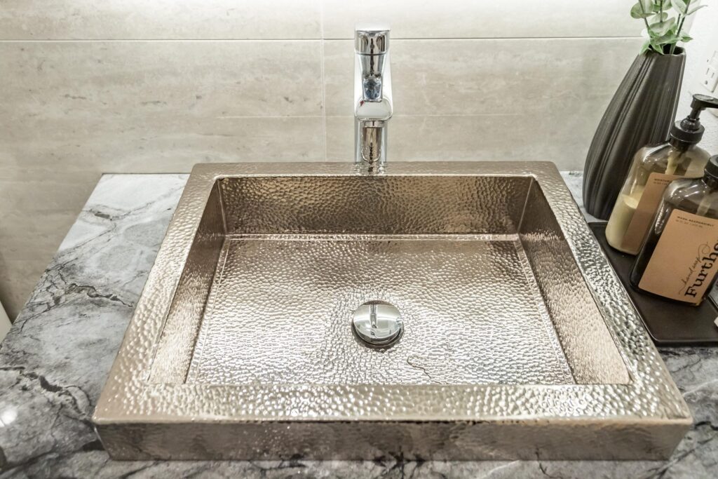 Narrow bathroom remodel by Elbaz Construction with textured wave-pattern wall tile, a walk-in shower with bench and niche, a backlit mirror and a floating vanity