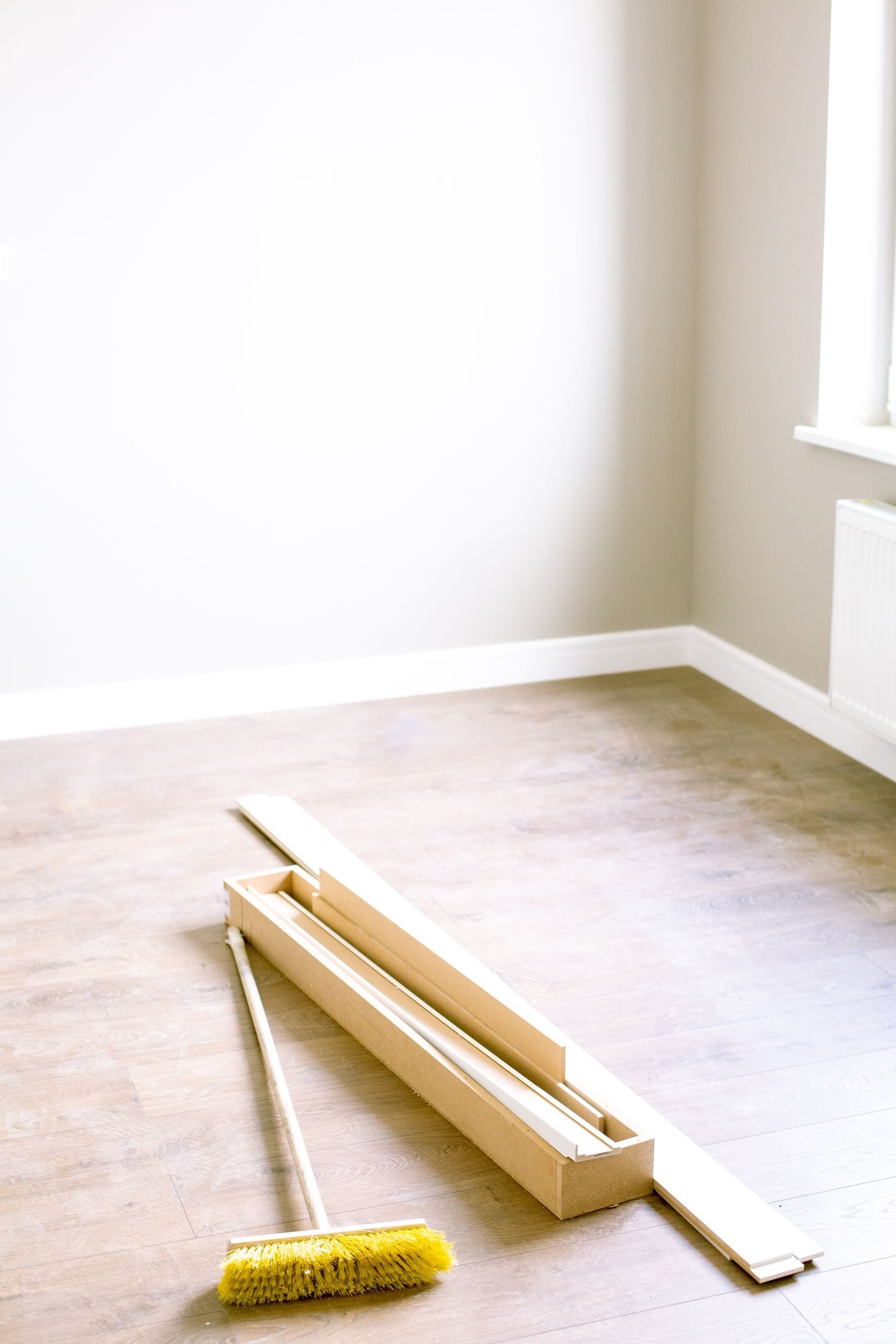 Room prepped for flooring installation with unopened plank boxes